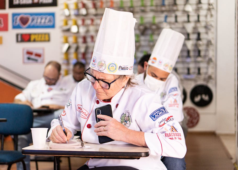 Chefs in a cooking class take notes and focus on learning new skills
