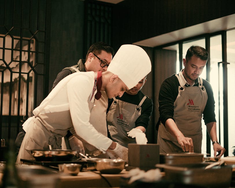 Team of chefs working together in a modern restaurant kitchen