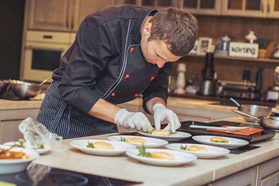 Chef meticulously plating dishes in a kitchen setting, showcasing culinary art