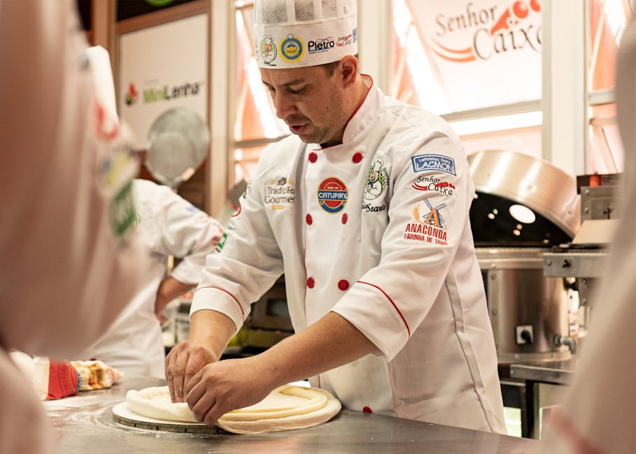 Chef kneading dough in a professional kitchen, showcasing culinary skills and uniform details