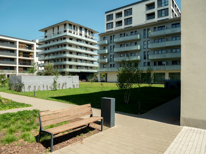 Contemporary apartment buildings with green spaces.